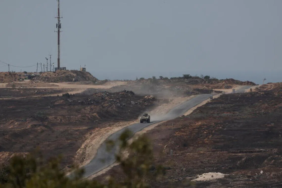 An Israeli military vehicle manoeuvres inside the Gaza strip, as seen from Israel, Aug 10, 2025.