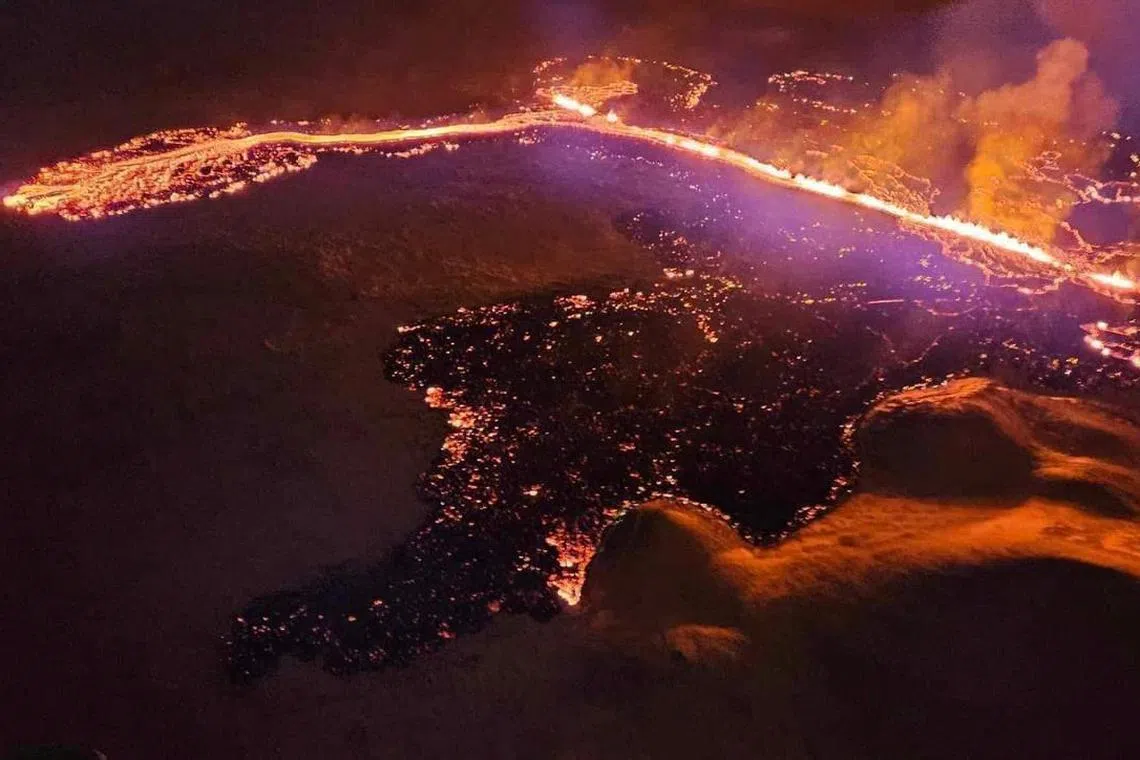 A volcano spewing lava and smoke as it erupts near Grindavik, Iceland on Dec 19.