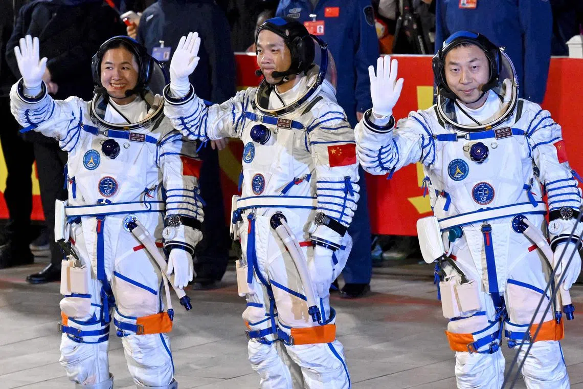 Astronauts Cai Xuzhe (right), Song Lingdong (centre) and Wang Haoze wave to the crowd during a departure ceremony ahead of the launch.