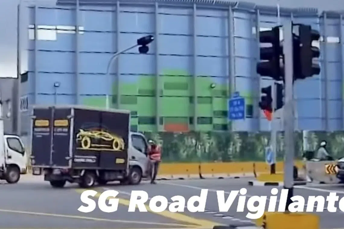 A video showed a man wearing a safety vest walking across the road at a pedestrian crossing, when a lorry runs into him.