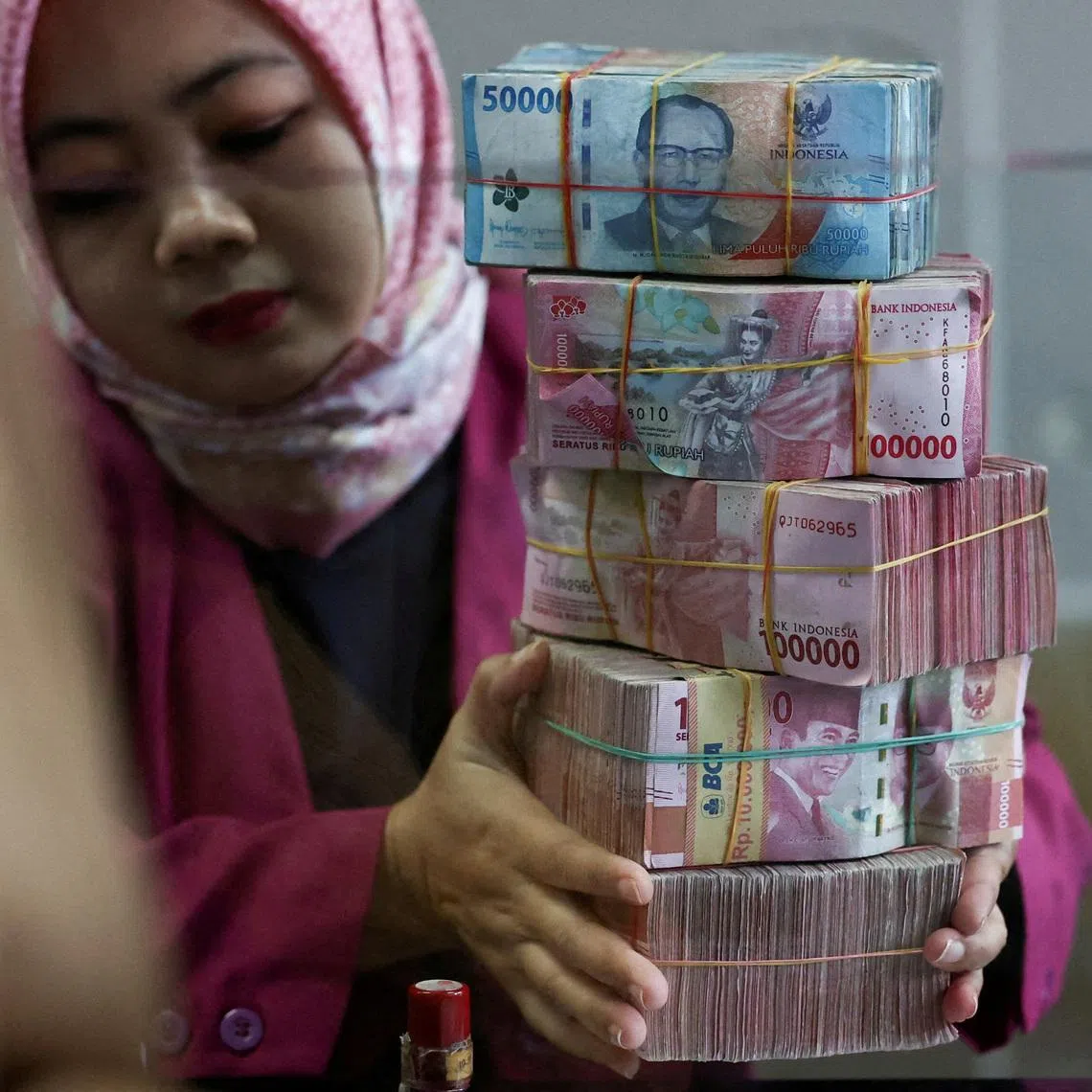 The rupiah slid to 16,985 per US dollar on Tuesday ahead of a policy decision by the central bank this week.