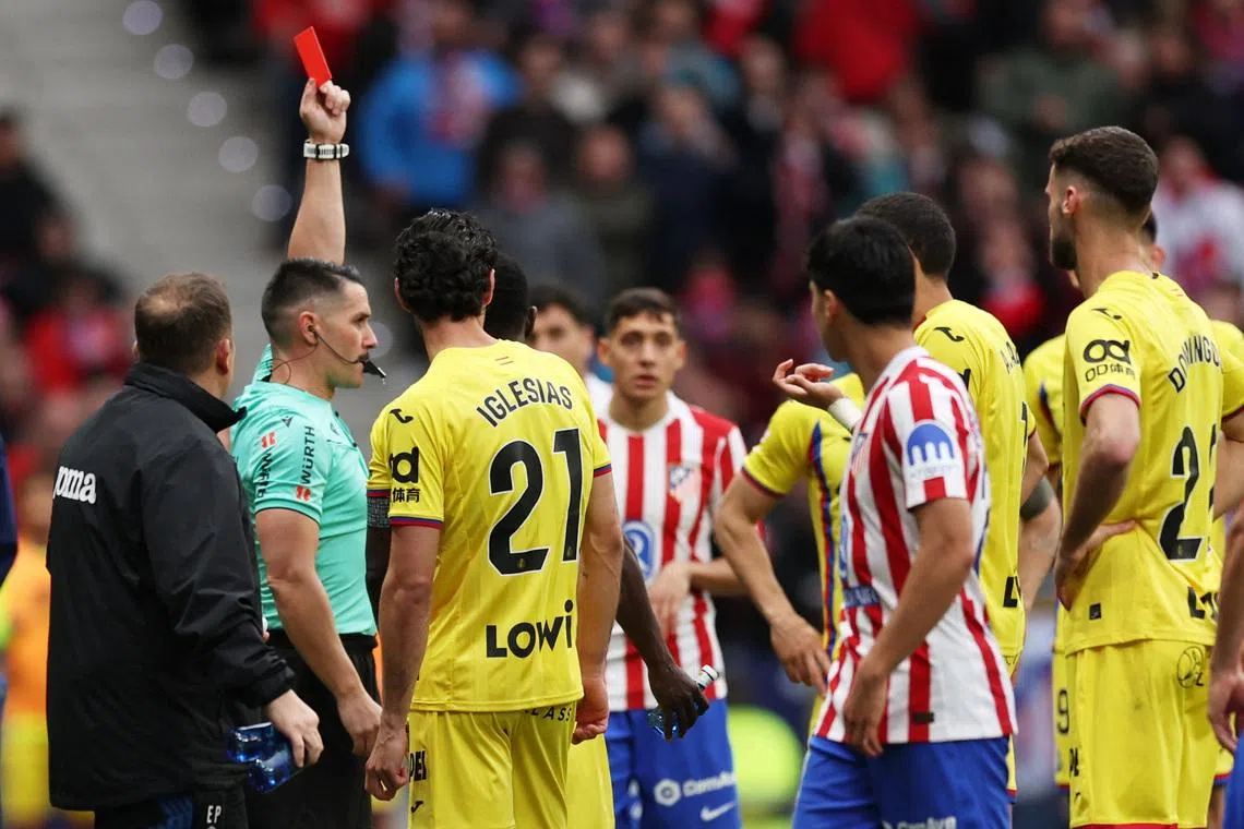 Soccer Football - LaLiga - Atletico Madrid v Getafe - Riyadh Air Metropolitano, Madrid, Spain - March 14, 2026 Referee Miguel Angel Ortiz Arias shows a red card to Getafe's Abdel Abqar after a VAR review REUTERS/Violeta Santos Moura