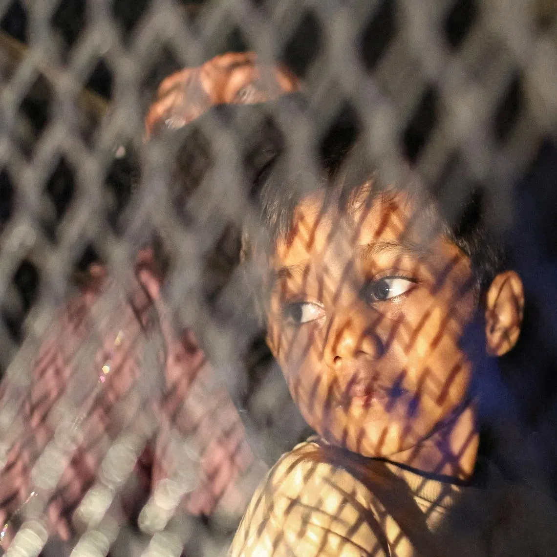 Rohingya refugees sit inside a truck as they are taken by police, in front of the office of the UN Refugee Agency, after being evicted from their homes, at Kuala Lumpur.