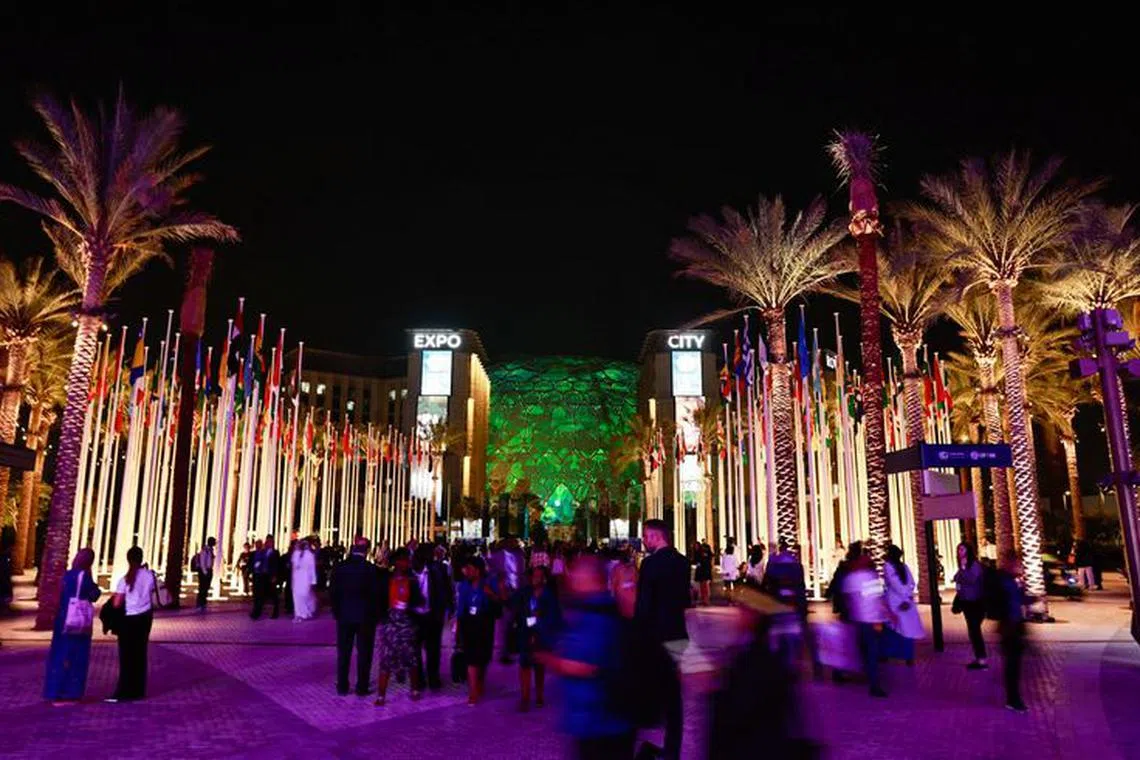Delegates walk at Dubai's Expo City during the United Nations Climate Change Conference (COP28), in Dubai, United Arab Emirates, December 2, 2023. REUTERS/Thaier Al-Sudani