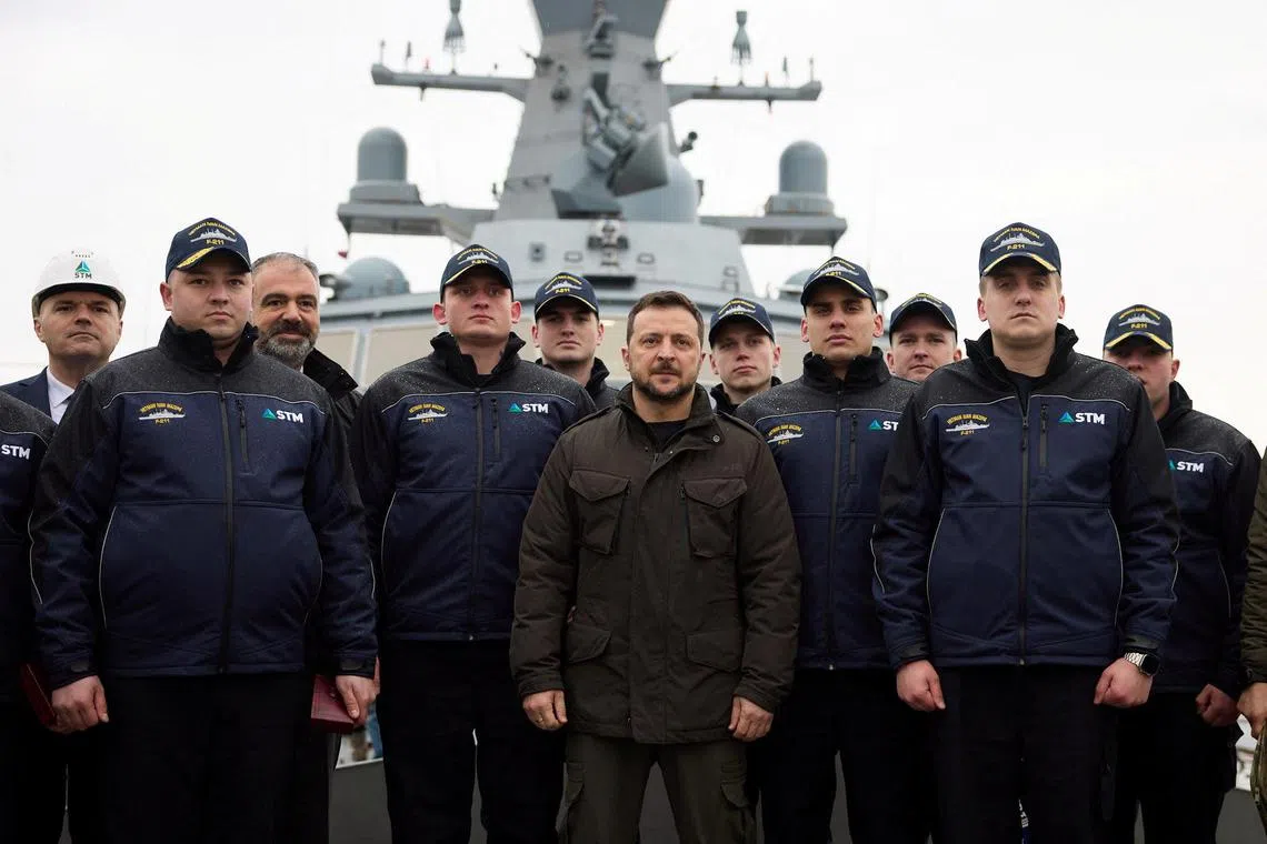 Ukrainian President Volodymyr Zelensky poses for a picture with the crew of a Ukrainian corvette, Ivan Mazepa, which is being built at a shipyard in Istanbul.