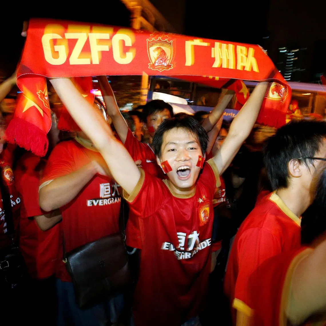 China's Guangzhou Evergrande fans celebrate after their team won the final match of the AFC Champions' League against South Korea's FC Seoul at Tianhe stadium in the southern Chinese city of Guangzhou, November 9, 2013. REUTERS/Bobby Yip/ File Photo