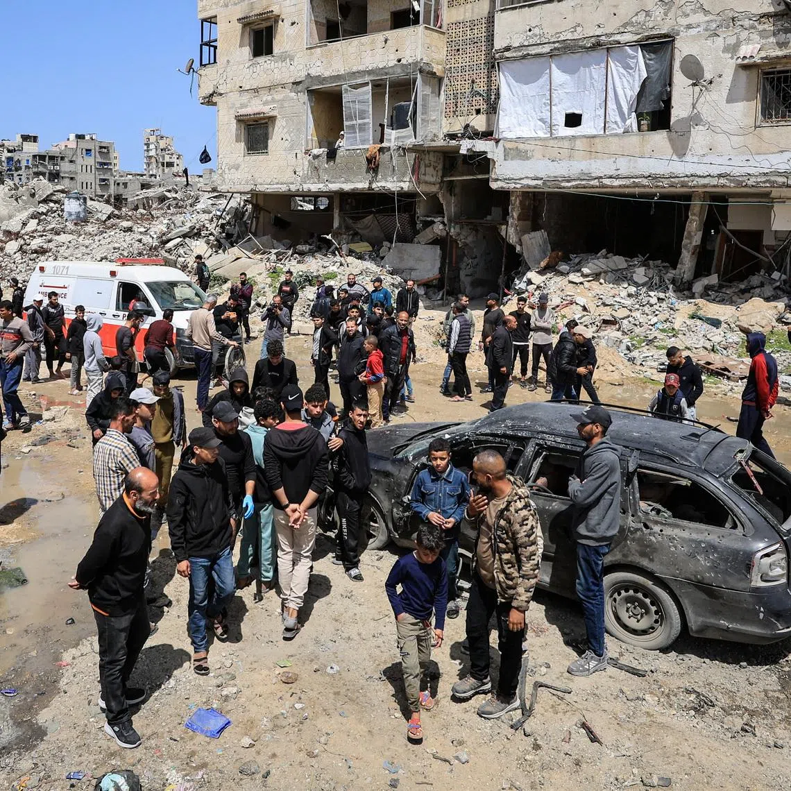 Palestinians inspect the damage after a person was hit by an Israeli strike while riding a bicycle, according to medics, in Gaza City, April 6, 2026. REUTERS/Dawoud Abu Alkas