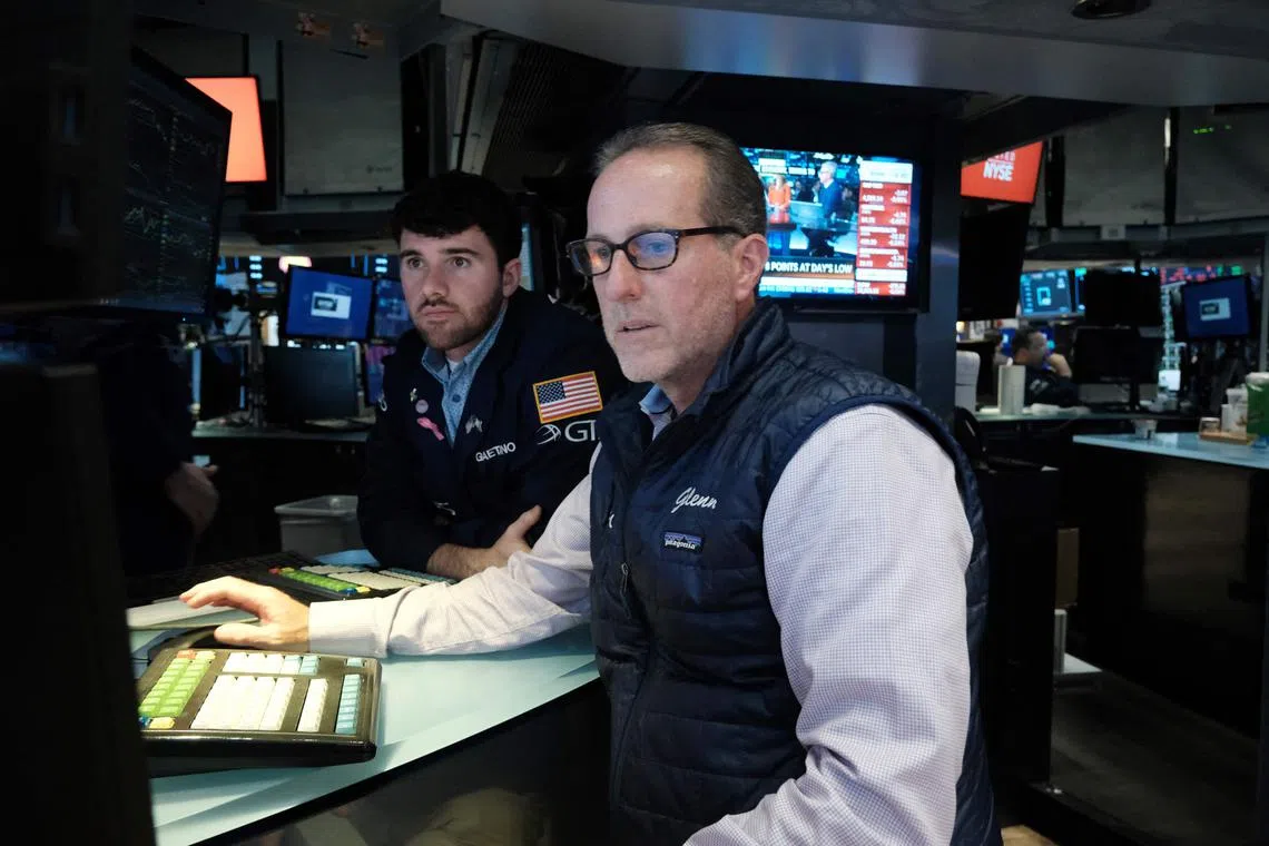 Traders work on the floor of the New York Stock Exchange, in New York City.