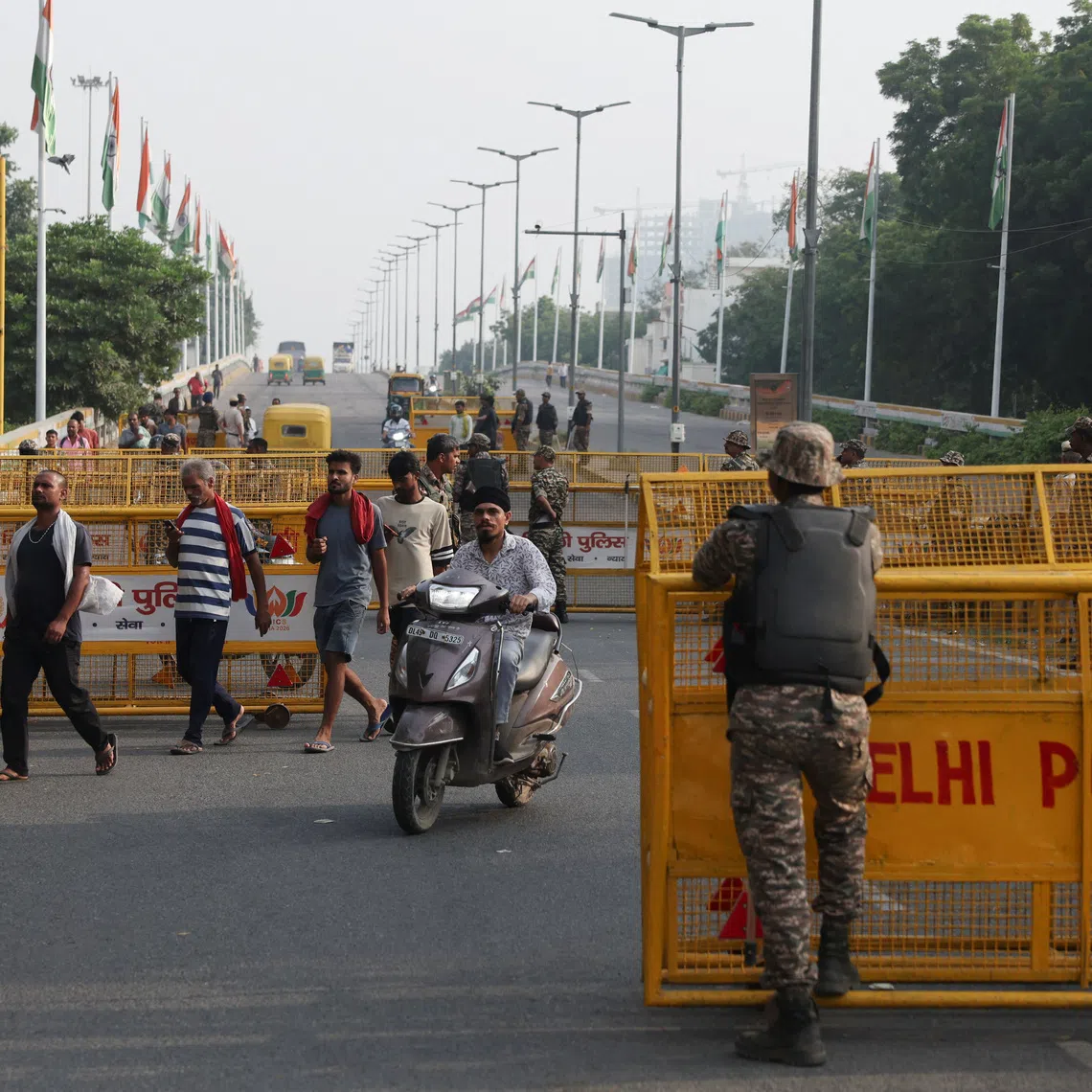 Police officers standing guard at a protest seeking the resignation of India’s chief election commissioner, Gyanesh Kumar, in New Delhi, on Oct 11.