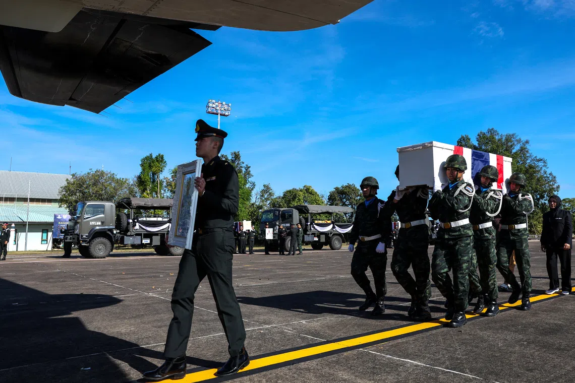Military personnel carry the coffin of Private Mustageem Chema, covered by the Thai national flag, during a procession ceremony to transport bodies to their home town, at a military airport amid deadly clashes between Thailand and Cambodia along a disputed border area, in Ubon Ratchathani province, Thailand, December 14, 2025. REUTERS/Athit Perawongmetha