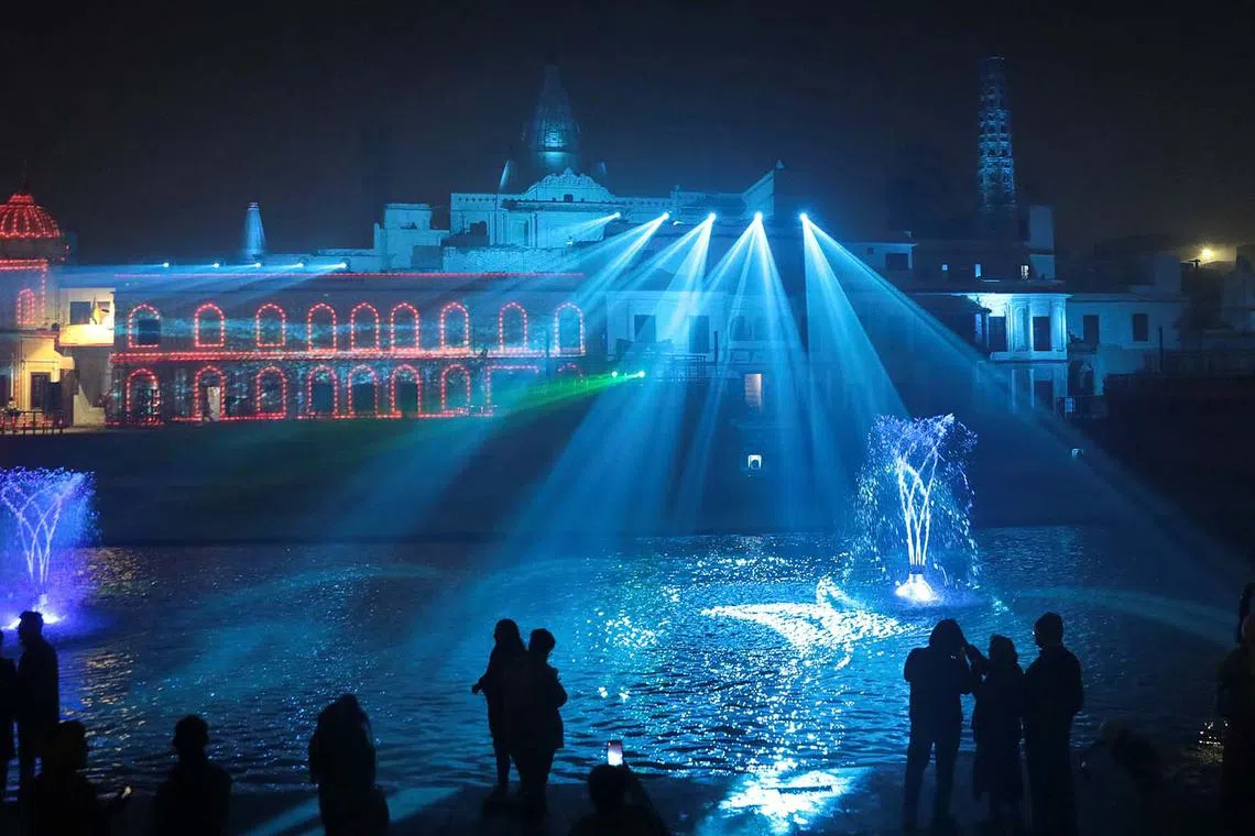 Hindu devotees watching a light and laser show at a Hindu temple near the bank of Sarayu river in Ayodhya, Uttar Pradesh, India, Dec 28, 2023. 