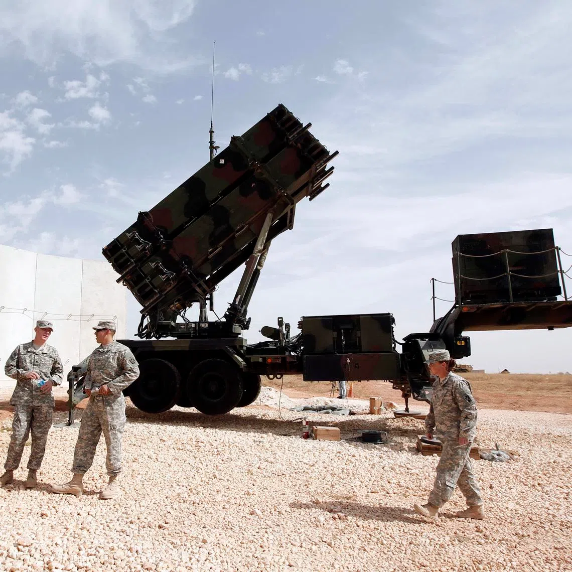 US soldiers stand beside a U.S. Patriot missile system at a Turkish military base in Gaziantep, southeastern Turkey, October 10, 2014. NATO Secretary-General Jens Stoltenberg of Norway is expected to visit U.S. patriot troops in Gaziantep later in the day.