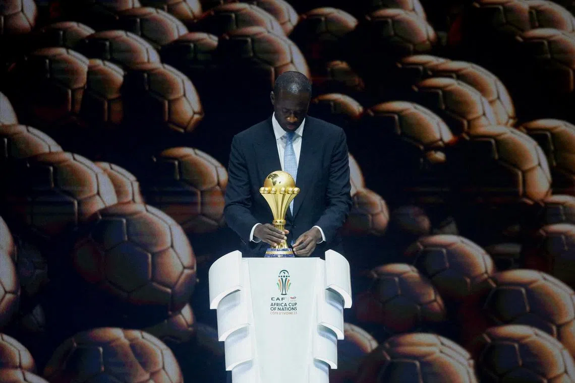 Soccer Football- Africa Cup of Nations draw.- The exhibition center of Abidjan, Ivory Coast - October 12, 2023. Yaya Toure holds the African Nations Cup during the draw. REUTERS/Luc Gnago