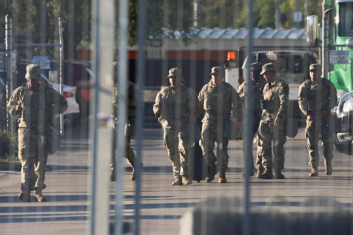 National Guard members walk at the US Immigration and Customs Enforcement (ICE) Broadview facility in Chicago, Illinois on Oct 9, 2025. 
