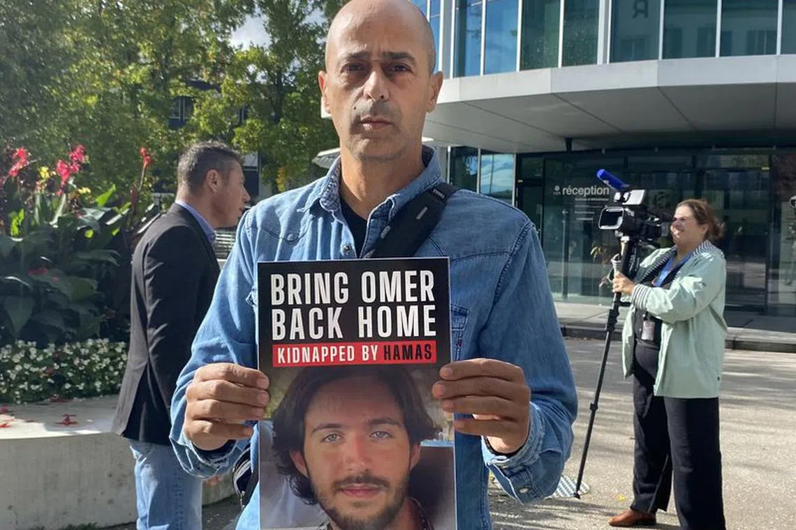 Assaf Shem Tov, uncle of Omer Shem Tov, a hostage taken to Gaza by Hamas, holds a sign calling for his nephew's release in front of the headquarters of the International Committee of the Red Cross (ICRC) in Geneva, Switzerland, October 20, 2023.  REUTERS/Gabrielle Tetrault-Farber