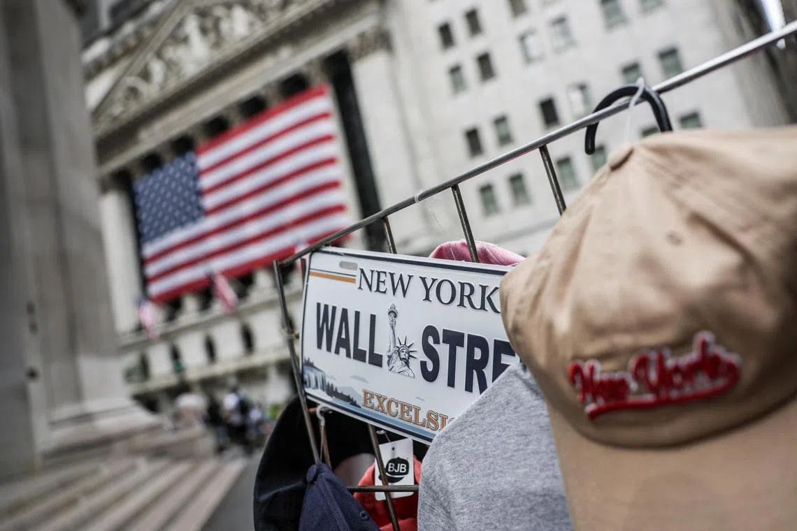 A Wall Street plate is seen on a street vendor stall outside the New York Stock Exchange (NYSE) in New York City, U.S., July 11, 2025. REUTERS/Jeenah Moon