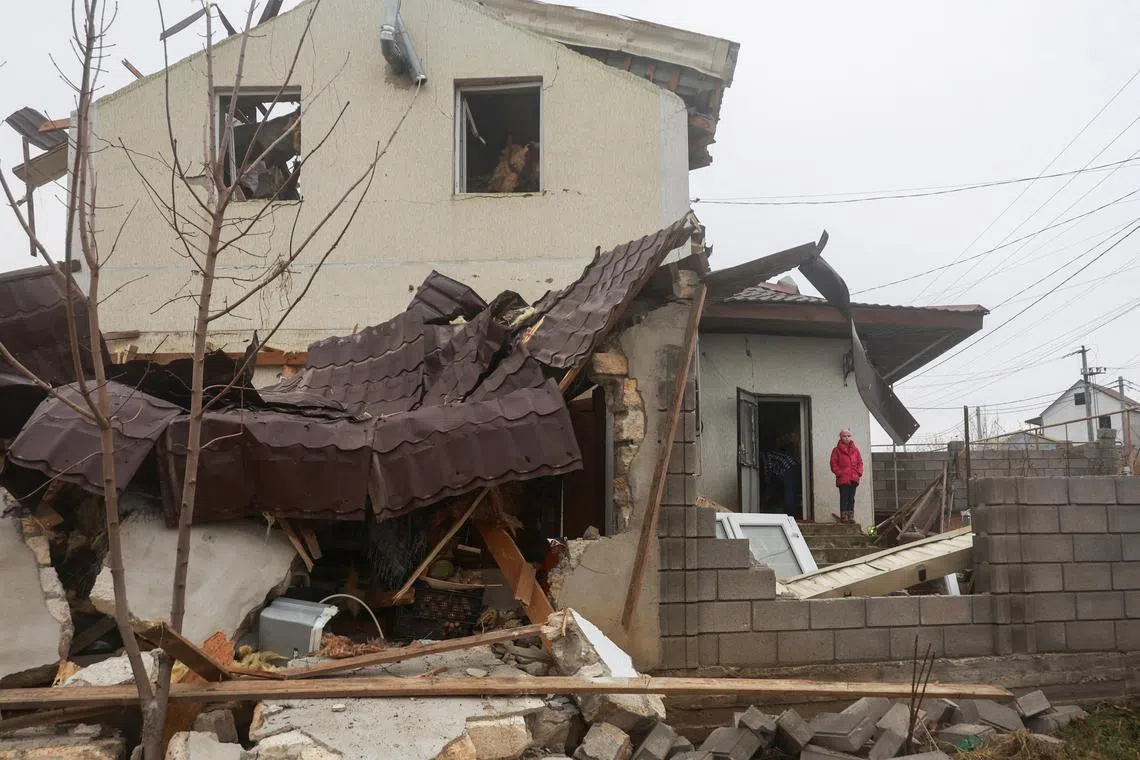 A girl stands next to her house damaged by a Russian missile strike, amid Russia's attack on Ukraine, on the outskirts of Odesa, Ukraine November 28, 2024. REUTERS/Nina Liashonok