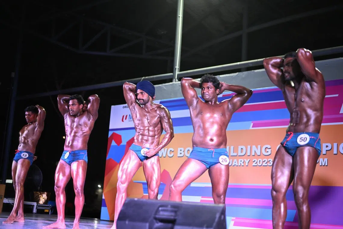 Participants preening and posing during the Migrant Workers' Centre Bodybuilding Championship at Migrant Workers' Centre Recreation Club on Feb 26, 2023.