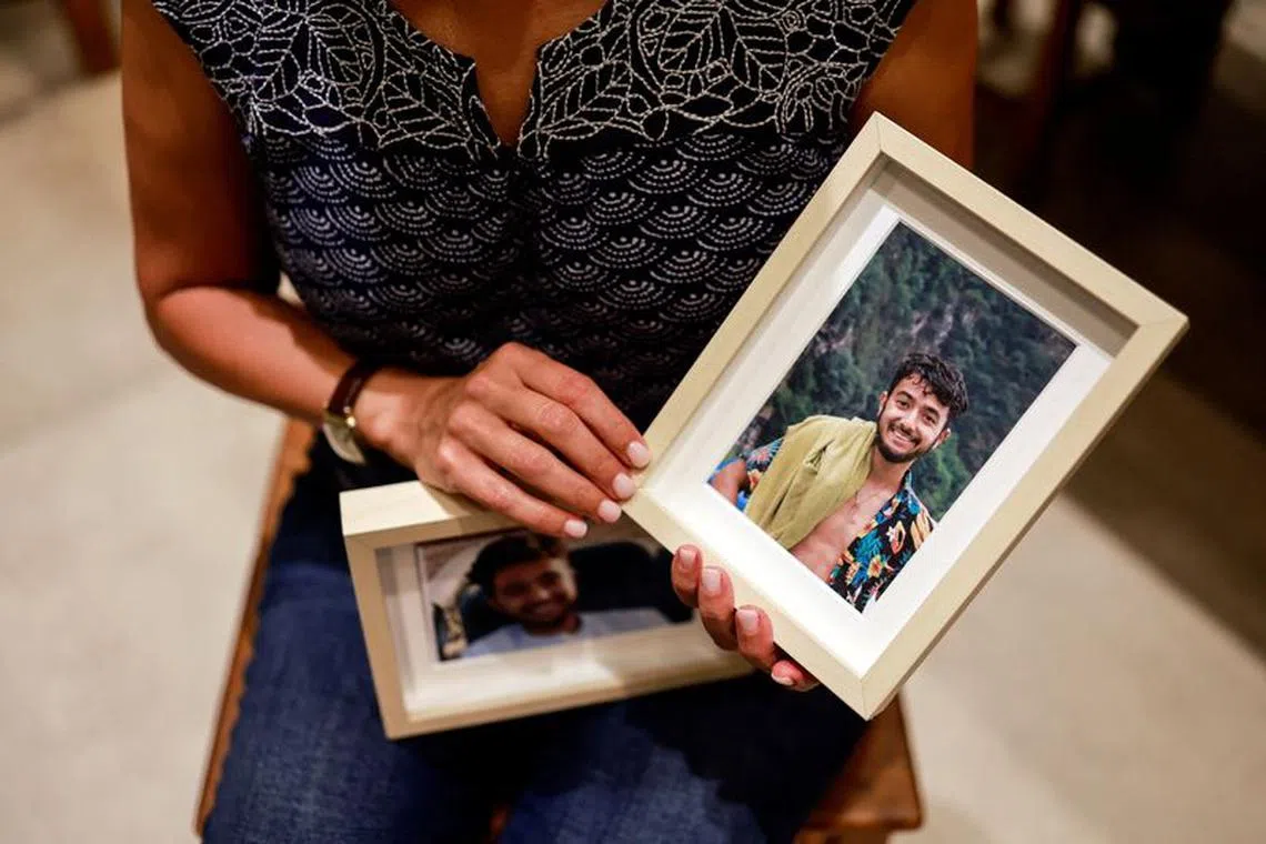 FILE PHOTO: Rachel Goldberg, U.S.-Israeli mother of Hersh Goldberg Polin, which was taken hostage by Hamas militants into the Gaza Strip while attending a music festival in south Israel, holds photos of her son in their home, in Jerusalem October 17, 2023 REUTERS/Ammar Awad/File Photo