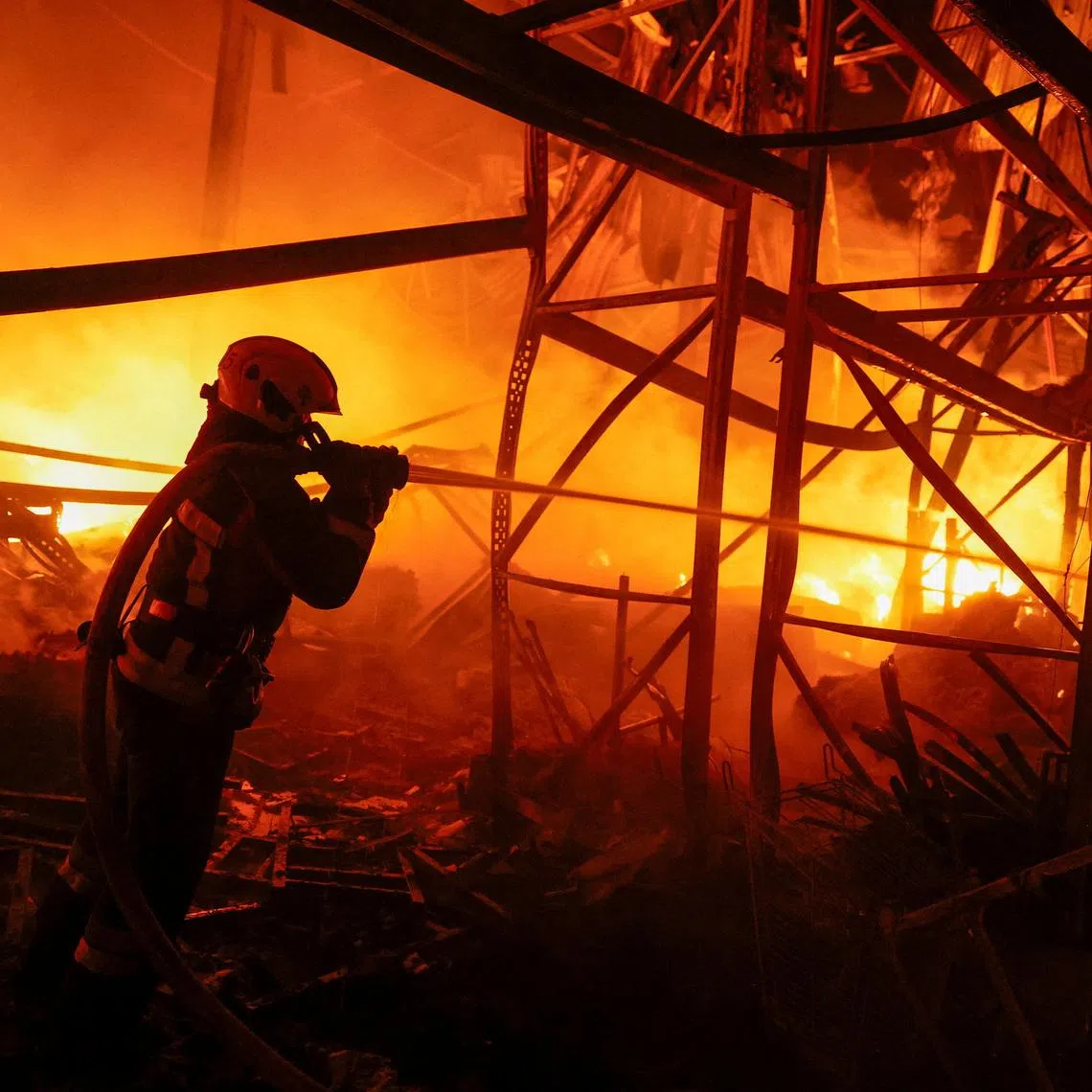 A firefighter works at a compound of a warehouse damaged during Russian missile strikes, amid Russia's attack on Ukraine, in Kyiv, Ukraine July 16, 2026. REUTERS/Valentyn Ogirenko