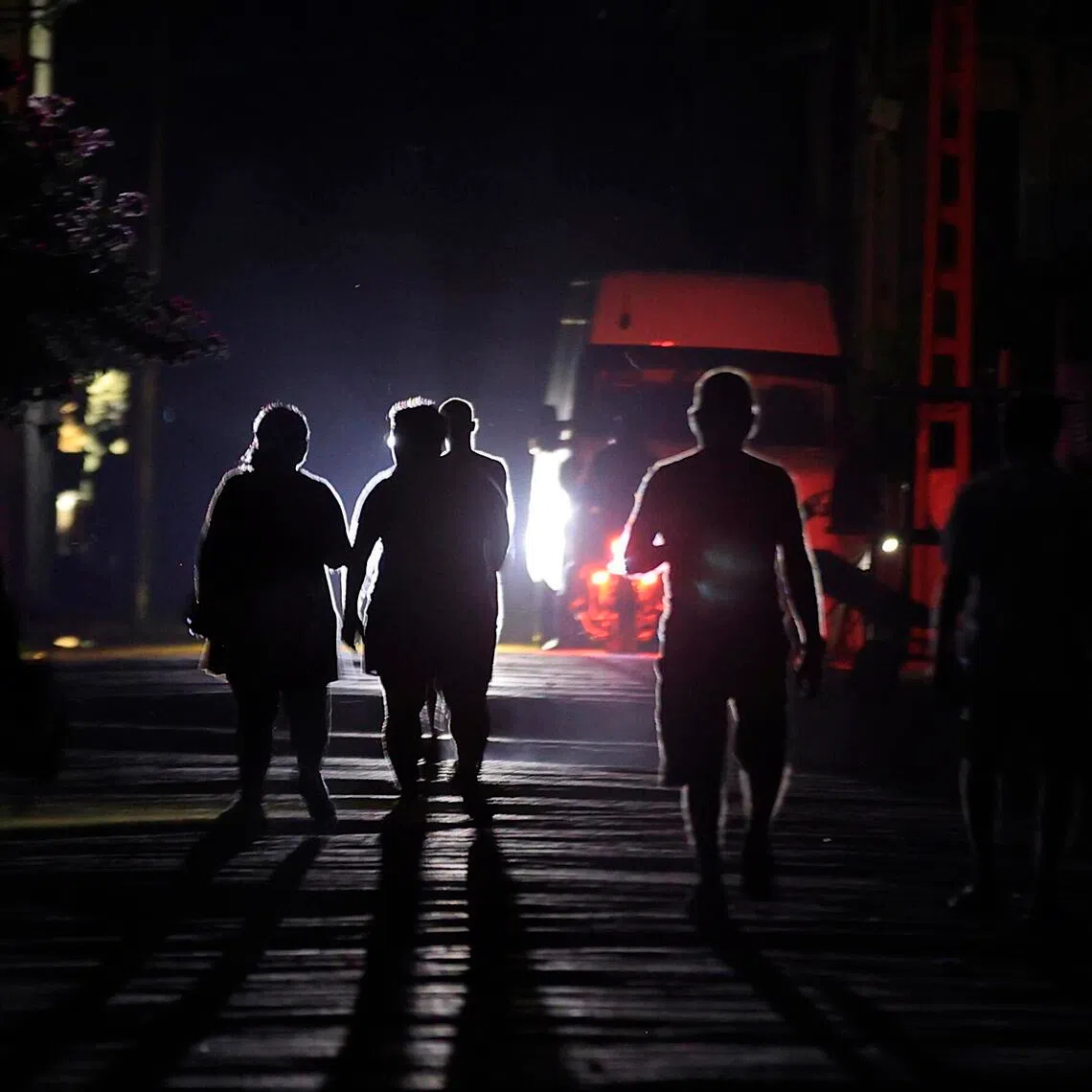 People walk down a street during a power outage in Havana, Cuba.