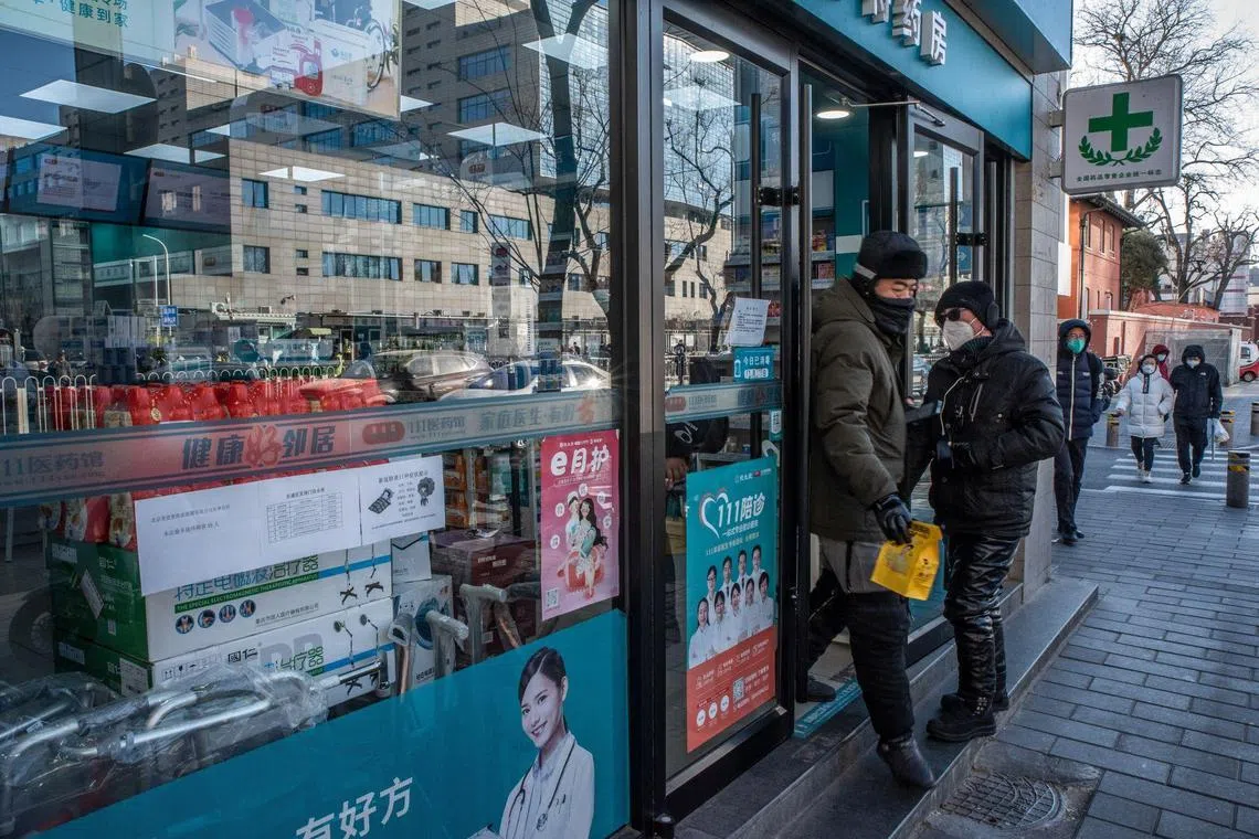 A man steps out of a pharmacy in Beijing, on Dec 29, 2022.
