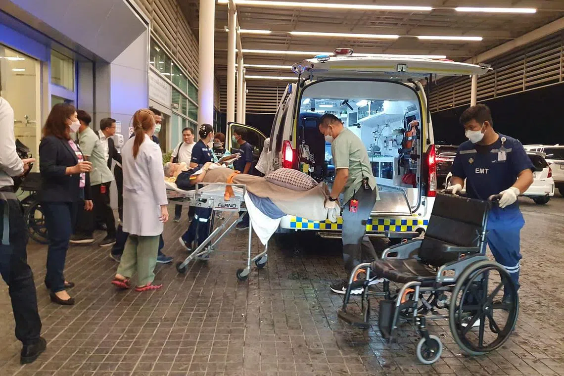 Hospital staff at Samitivej Srinakarin Hospital in Bangkok wheeling an injured passenger from Flight SQ321 into an ambulance on May 21.