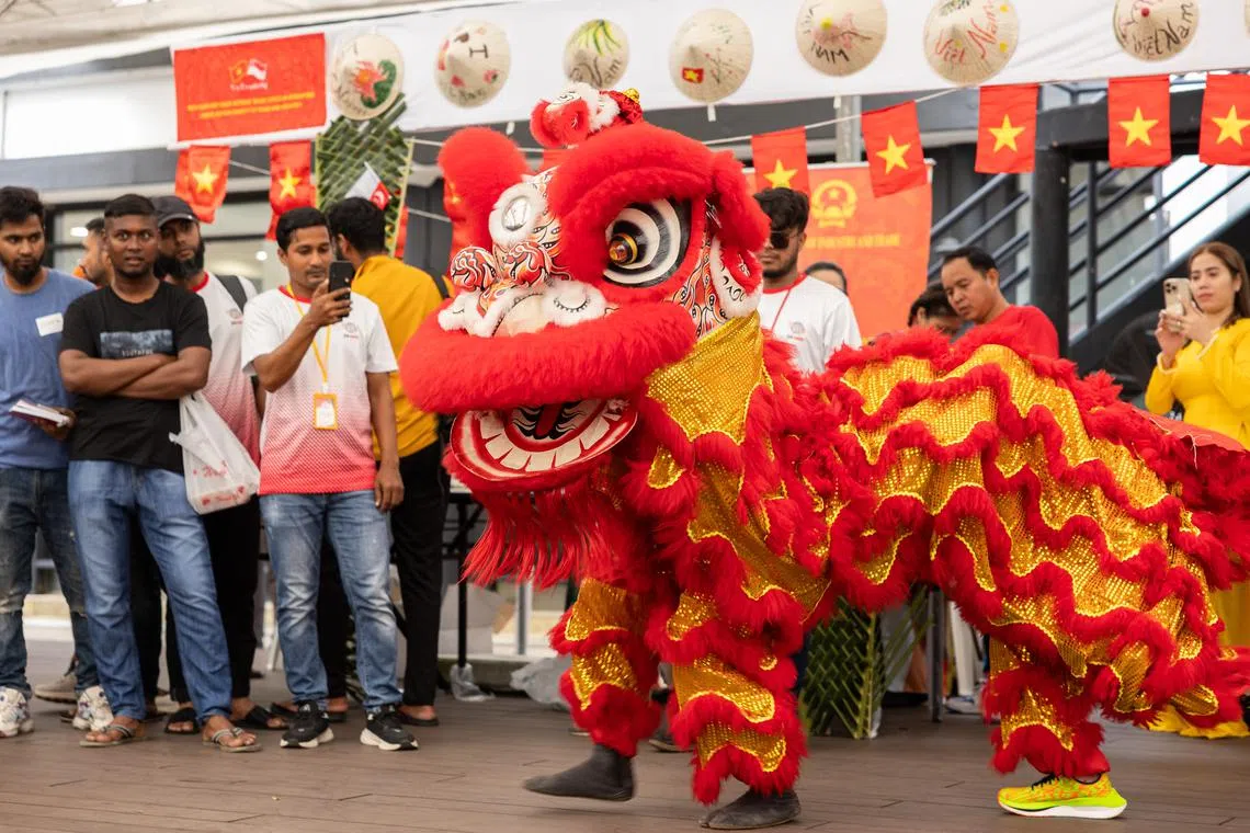 Migrant workers watching a lion dance performance during Racial Harmony Day celebrations at Sembawang Recreation Centre on July 21.