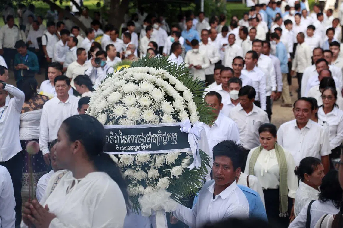 People attending a ceremony marking National Day of Remembrance at the Choeung Ek Genocidal Centre on the outskirts of Phnom Penh, Cambodia, May 20, 2025. Cambodians mark the annual National Day of Remembrance, also known as the Day of Anger, to commemorate the estimated two million victims who died from starvation, forced labor, or politically-justified executions during the Khmer Rouge regime from 1975-1979. 
