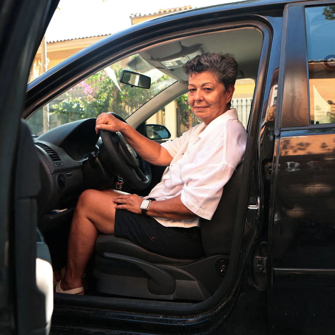 Pilar Lopez poses inside the car where she slept for two months after she was evicted this summer from the apartment where she had lived for 12 years, in Palma de Mallorca, Spain, September 27, 2026. REUTERS/Francisco Ubilla