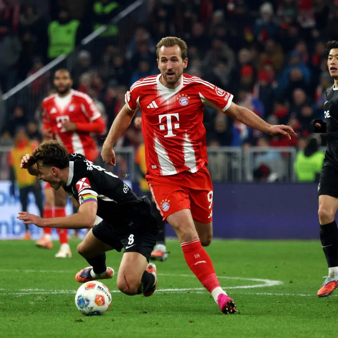 Bayern Munich's Harry Kane and Freiburg's Maximilian Eggestein vie for the ball during a Bundesliga match.