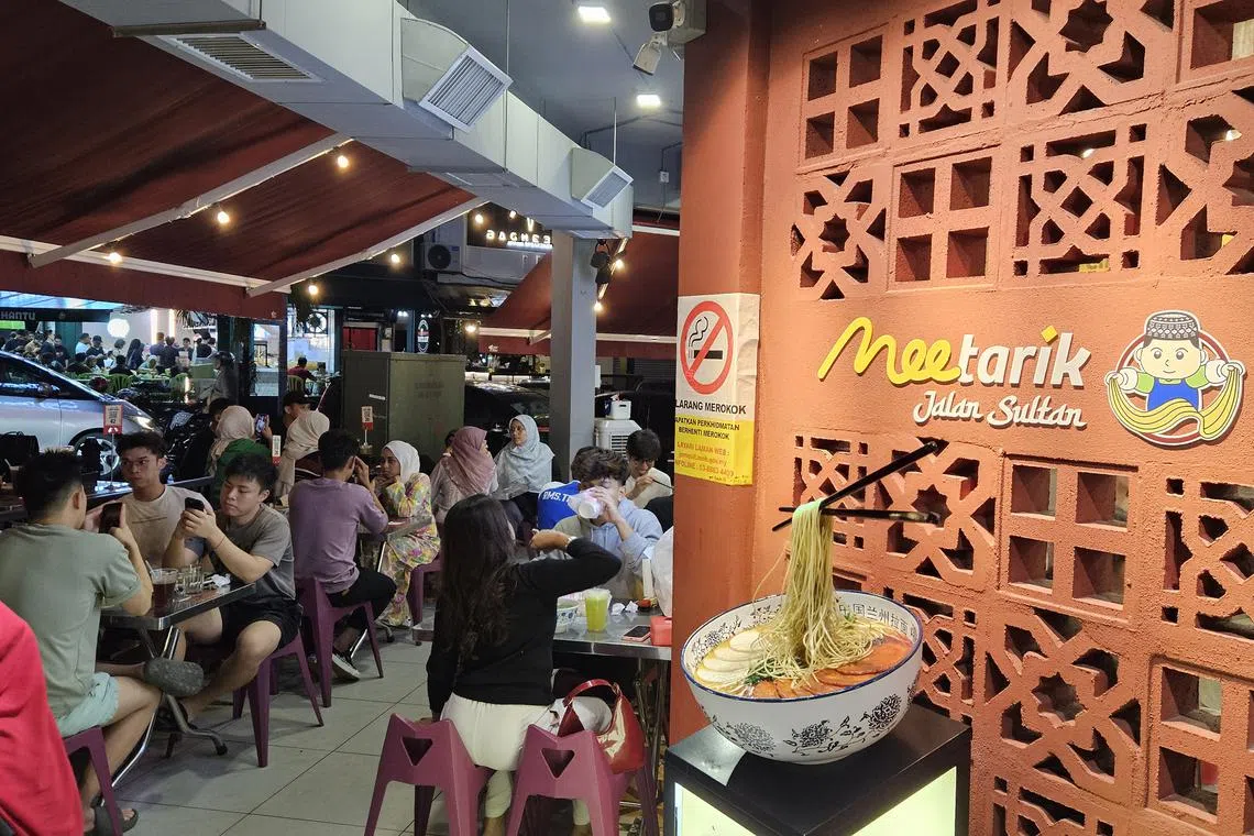 In a packed eatery on Jalan Sultan, young diners tuck into mee tarik and cumin-scented lamb skewers.