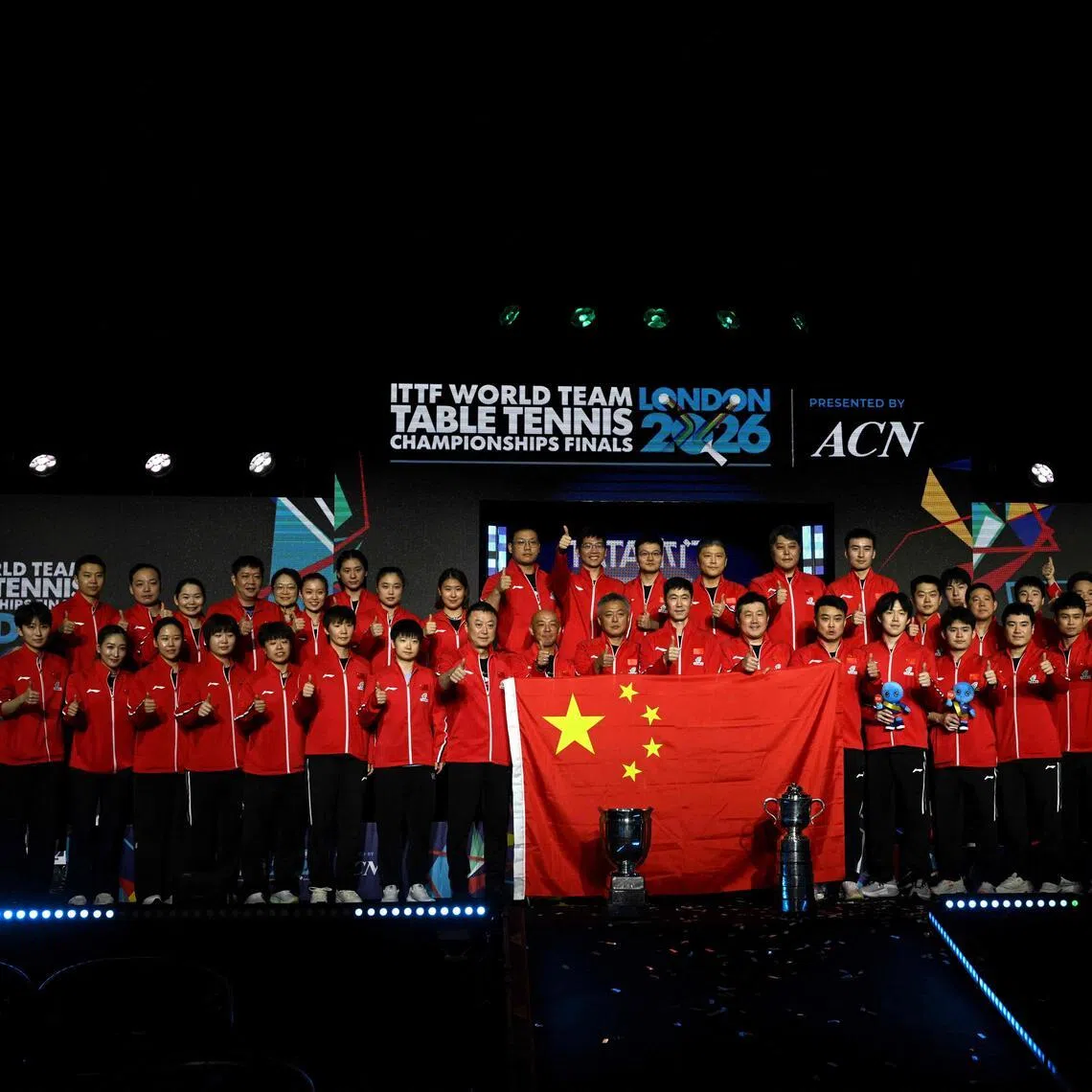 China's men's and women's teams pose for a photo after winning the team final matches at the ITTF World Table Tennis Championships in Wembley Arena, west London on May 10, 2026. 