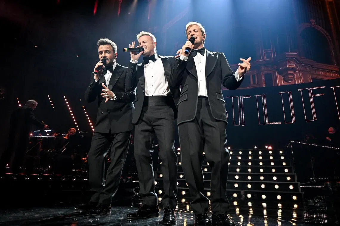 Westlife's Shane Filan, Nicky Byrne and Kian Egan during their performance at the Royal Albert Hall in London, England, on Oct 27. 