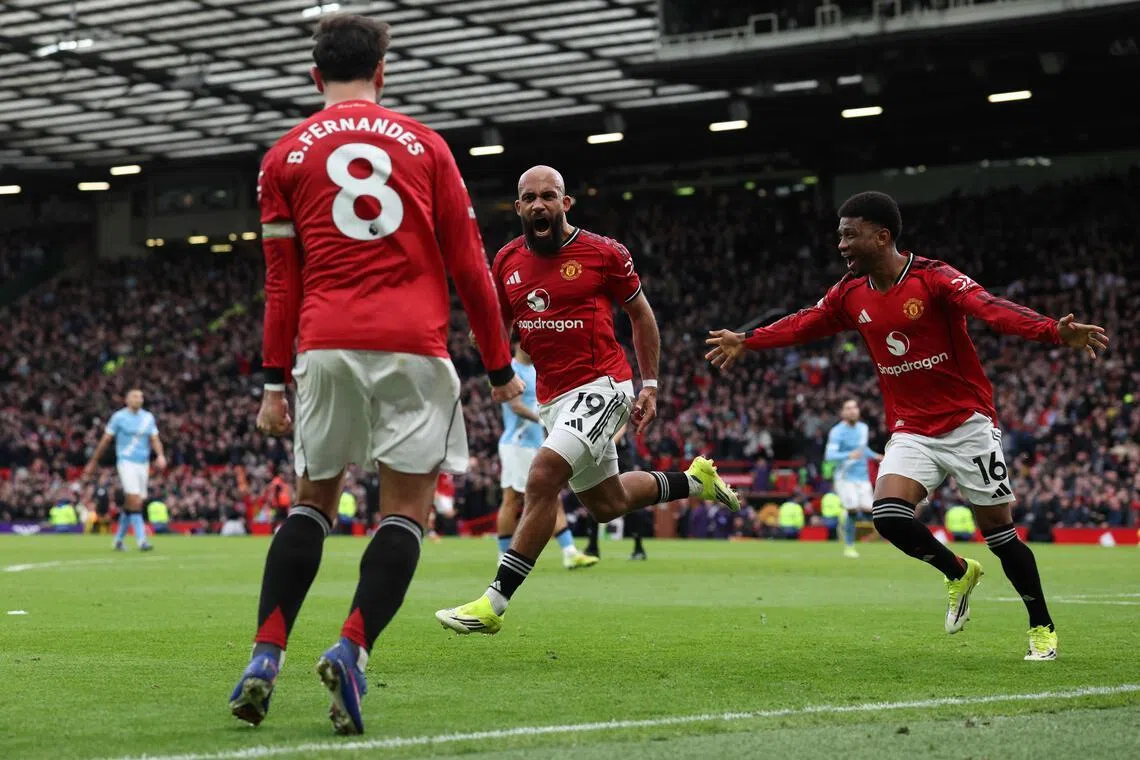 Manchester United's Bryan Mbeumo celebrates with Amad Diallo and captain Bruno Fernandes after scoring the first goal against Manchester City in their Premier League clash at Old Trafford.