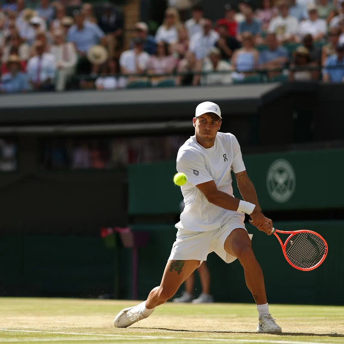 Flavio Cobolli hits a backhand against Alex de Minaur on day eight of Wimbledon.