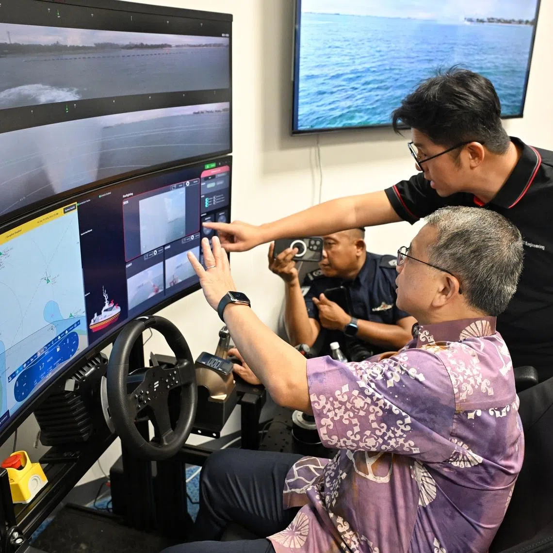 Second Minister for Home Affairs Edwin Tong trying his hand at an unmanned surface vessel control during a tour of the new SCDF Marine Division Headquarters on June 19.