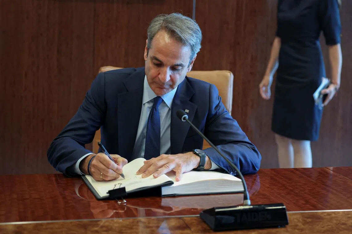 FILE PHOTO: Kyriakos Mitsotakis, prime minister of Greece, signs the guestbook upon his meeting with United Nations Secretary General Antonio Guterres (not pictured) at U.N. Headquarters in New York City, U.S., May 20, 2025. REUTERS/Jeenah Moon/File photo
