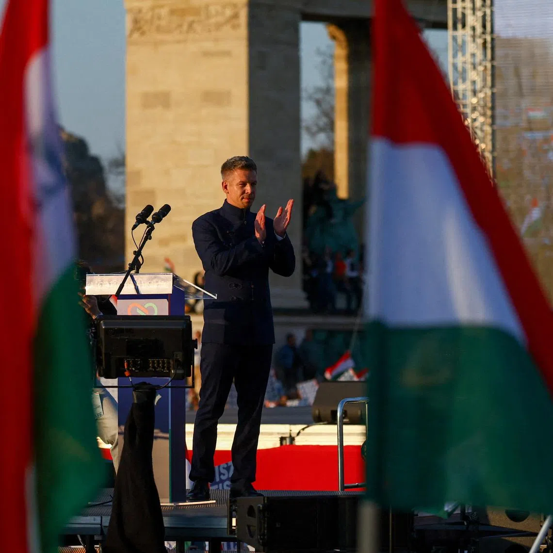 FILE PHOTO: Peter Magyar, leader of the opposition Tisza party, claps on stage during Hungary's National Day celebrations, which also commemorates the 1848 Hungarian Revolution against Habsburg rule, in Budapest, Hungary, March 15, 2026. REUTERS/Bernadett Szabo/File Photo