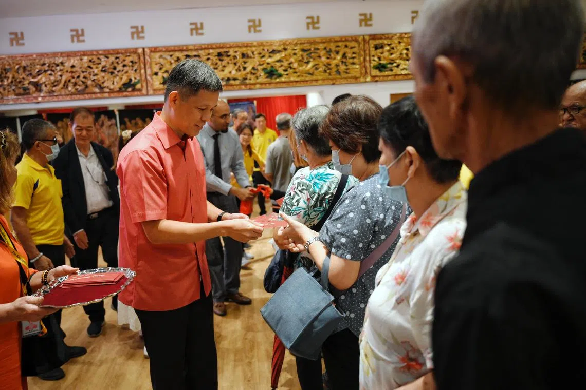 Minister for Education Chan Chun Sing distributes red packets at the Singapore Buddhist Lodge 77th Batch Hong Bao Distribution Event on Jan 11, 2025.