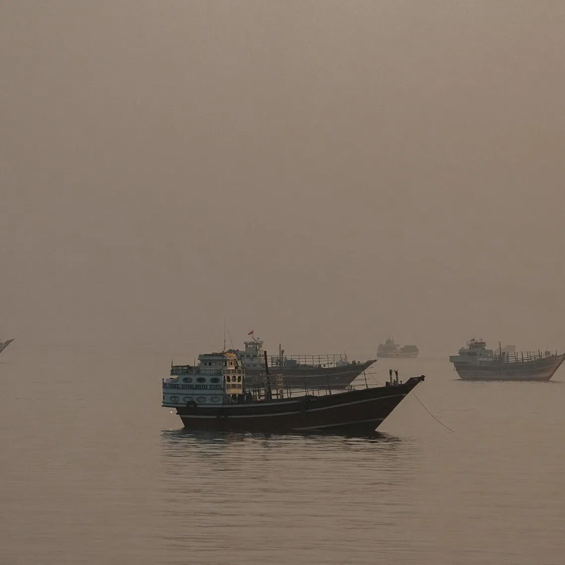 Vessels anchored in the Strait of Hormuz as seen from Musandam, Oman, on June 3, 2026.