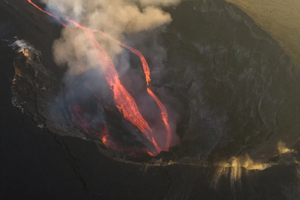 A drone view shows molten lava flowing inside a crater during an eruption of Mount Etna, in Sicily, Italy, August 13, 2026. REUTERS/Giuseppe Di Stefano