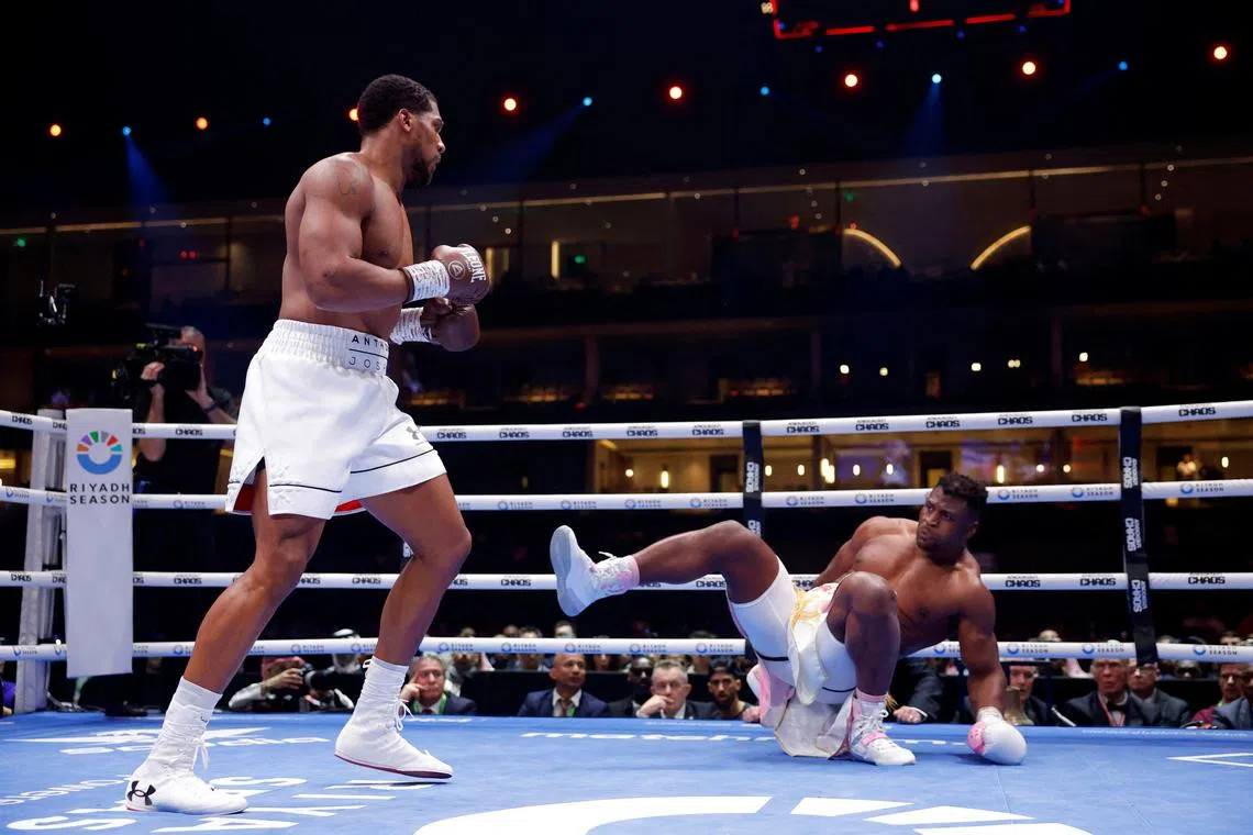 Boxing - Anthony Joshua v Francis Ngannou - Kingdom Arena, Riyadh, Saudi Arabia - March 9, 2024 Anthony Joshua knocks down Francis Ngannou REUTERS/Andrew Couldridge