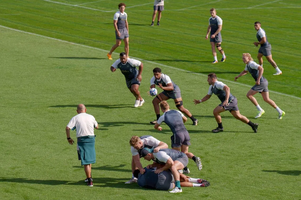 Australian players run through a drill under the scrutiny of head coach Eddie Jones (left) during a training session.