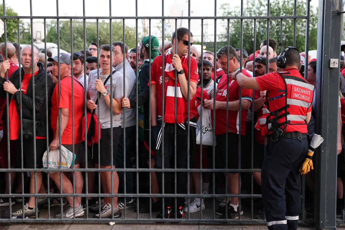 Liverpool fans stand outside the Stade de France unable to get in in time for the Champions League final against Real Madrid on May 28.