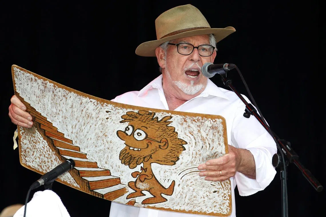 FILE PHOTO: Australian singer Rolf Harris performs with his wobbleboard at the Glastonbury Festival 2010 in south west England, June 25, 2010.   REUTERS/Luke MacGregor/File Photo