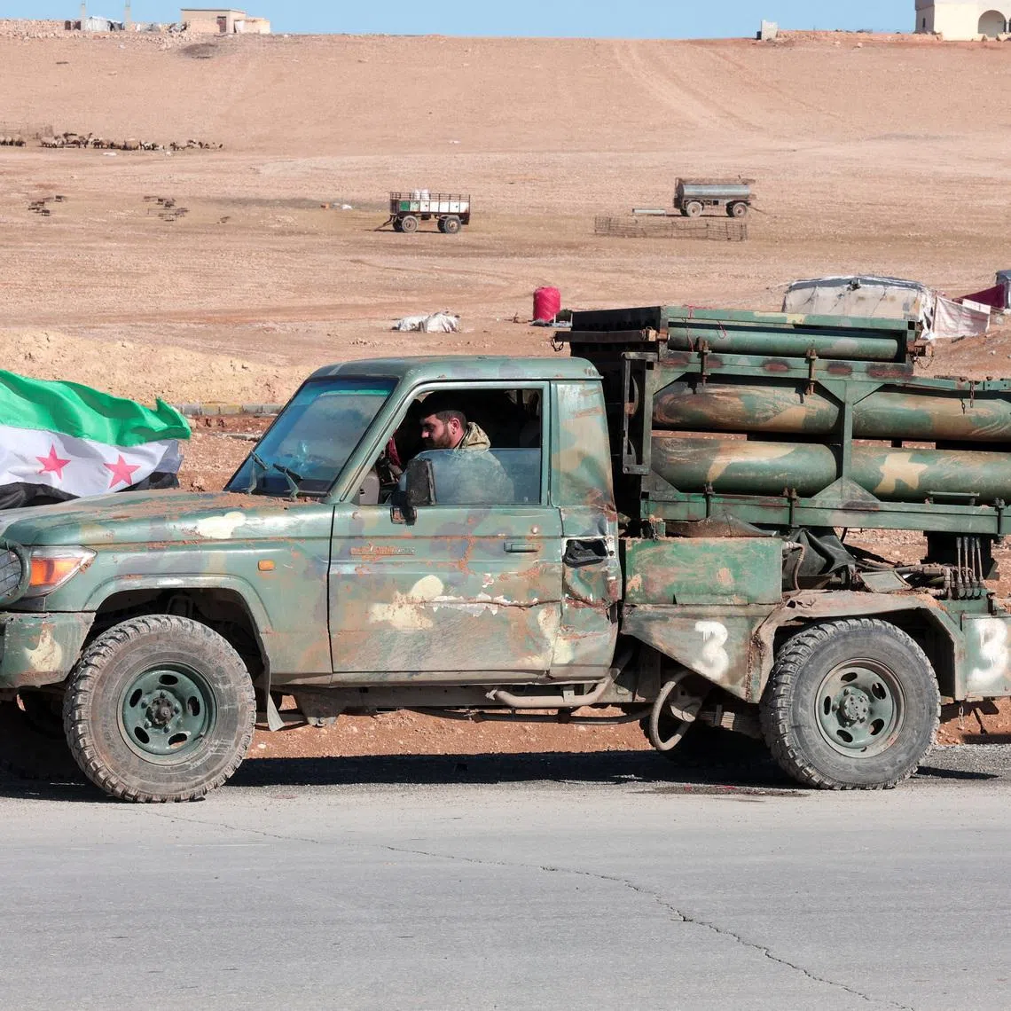 A military vehicle of the Syrian army is parked on the highway near Tabqa, after the Syrian army took control of it, Syria, January 19, 2026. REUTERS/Mahmoud Hassano