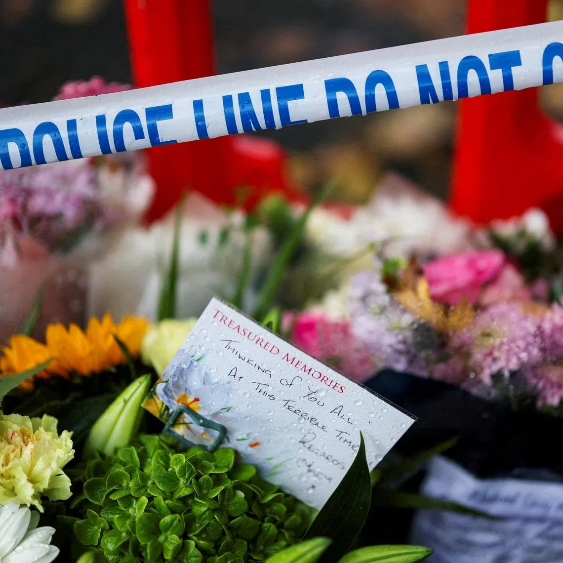A note is left with floral tributes near the Manchester synagogue, where multiple people were killed on Yom Kippur, on Oct 4, 2025.