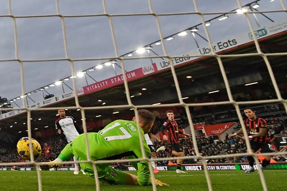 Fulham's German goalkeeper Bernd Leno (left) is unable to stop a shot from Bournemouth's Justin Kluivert (right) for the first goal of the match.