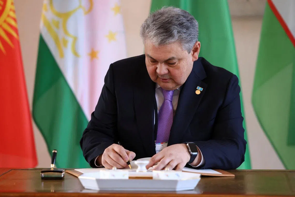 The foreign minister of Kazakhstan, Yermek Kosherbayev, signs a guestbook at Bellevue Palace in Berlin, Germany, February 11, 2026. REUTERS/Christian Mang